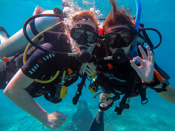 Two new scuba divers underwater.