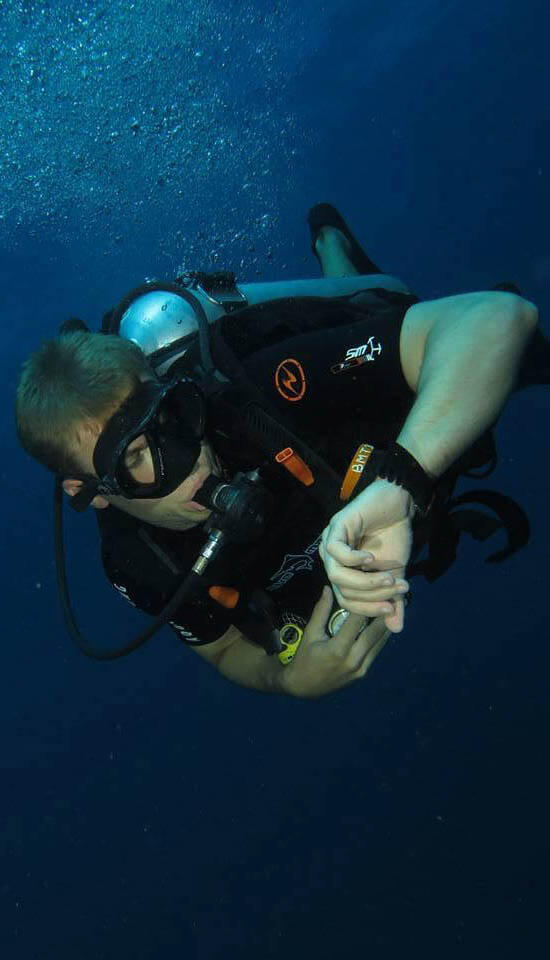 A diver checks his dive computer.